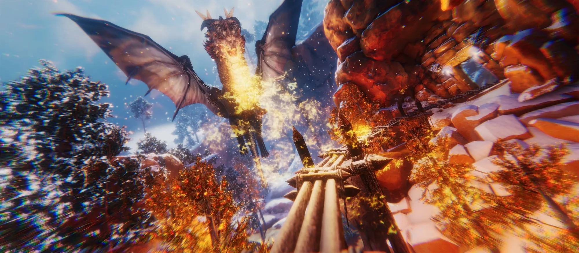 A dragon breathing fire over a snowy cliffside from a VR slide ride